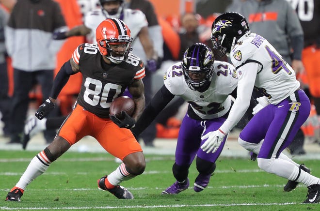 Browns wide receiver Jarvis Landry (80) turns up the field for yards after a catch against Baltimore Ravens cornerback Jimmy Smith (22) and Baltimore Ravens cornerback Marlon Humphrey (44) during the first half of an NFL football game, Monday, Dec. 14, 2020, in Cleveland, Ohio. [Jeff Lange/Beacon Journal]