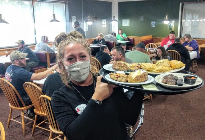 Server Stevie Maurer in the dining room at The Chop House in Carrollton.
