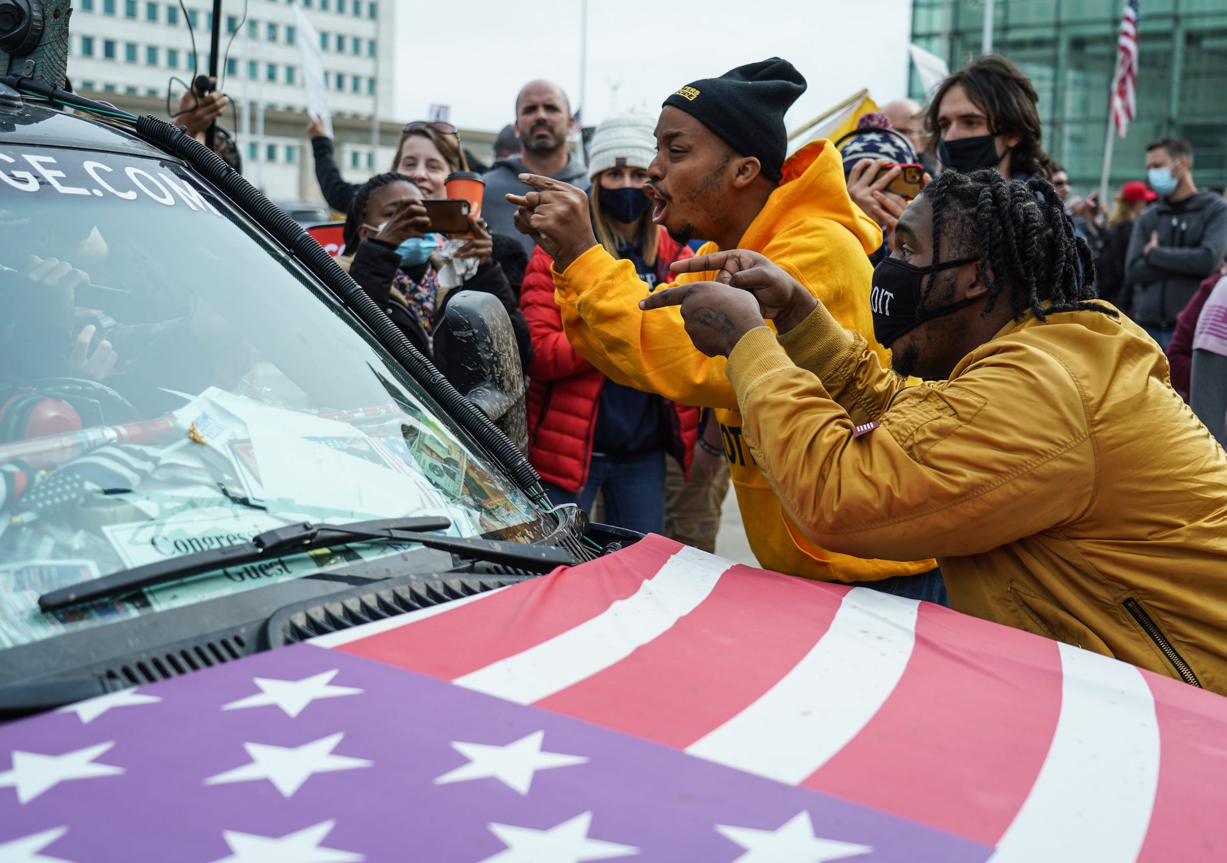 Trump supports rally outside of the TCF Center to rally in support of their candidate as Biden supporters counter-protest. Angelo Austin (right) of Detroit and Ralph Gaines of Detroit argue with the driver hauling the Trump Unity Bridge as he drives by Trump supporters gathered outside of the TCF Center in Detroit on Nov 5th.