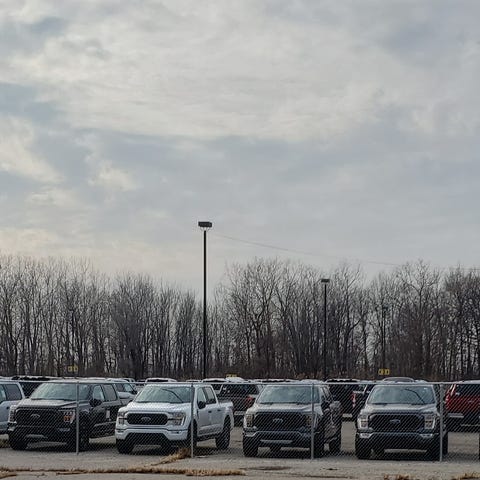 2021 Ford F-150 pickup trucks fill private parking