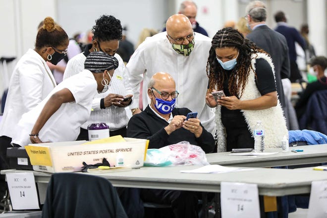 Absentee ballots are processed by election officials in the Detroit Elections Department Absentee Ballot counting room at TCF Center in Downtown Detroit on Nov. 4, 2020.