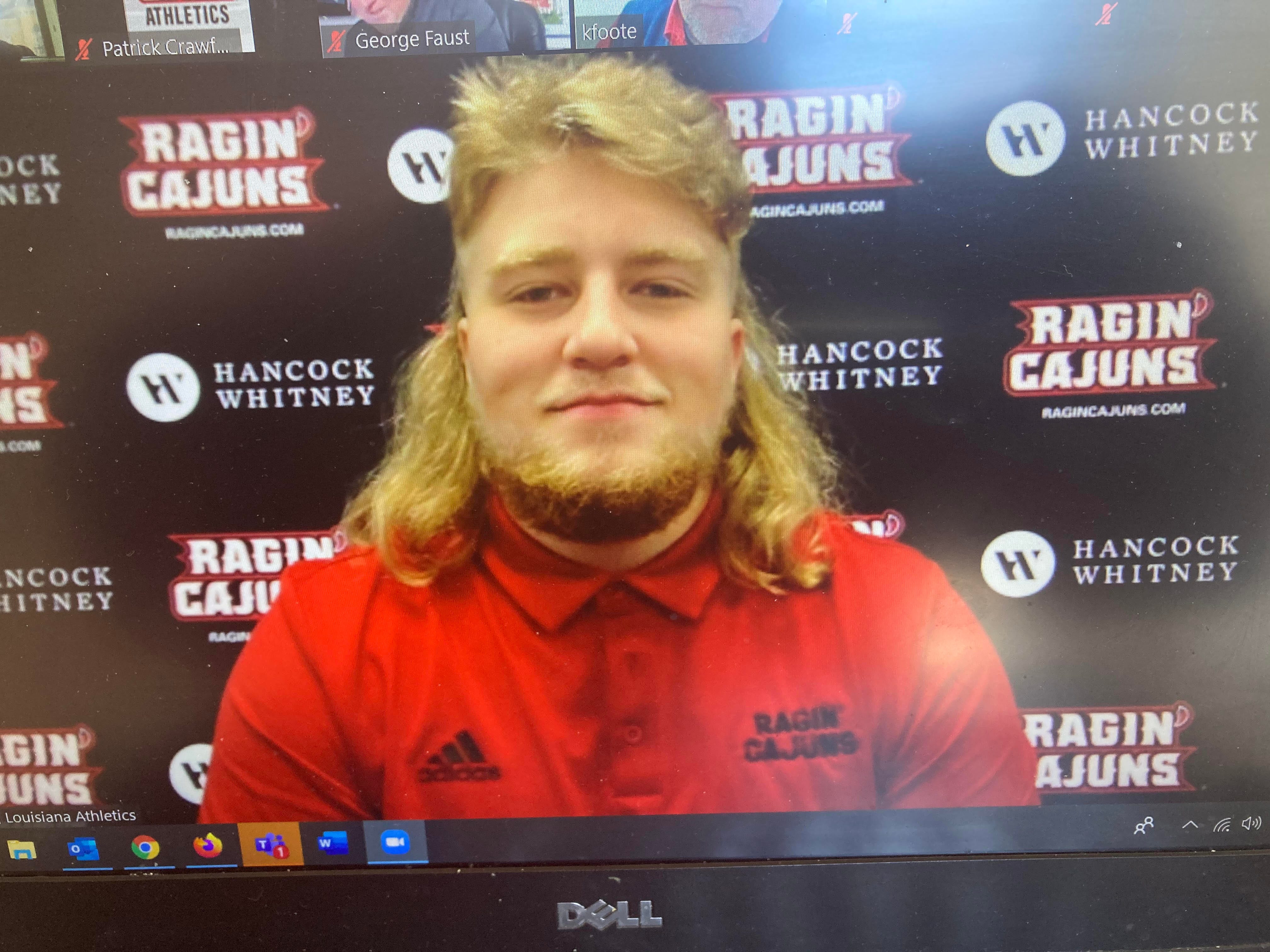 UL offensive lineman David Hudson proudly rocks his mullet during a recent Zoom conference with reports.