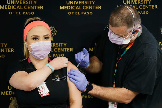 Sarah Ellis, a registered nurse at University Medical Center of El Paso, gets a COVID-19 vaccine Tuesday, Dec. 15, 2020, in El Paso. Over the next few days, it should receive about 2,900 doses of the vaccine, officials said.