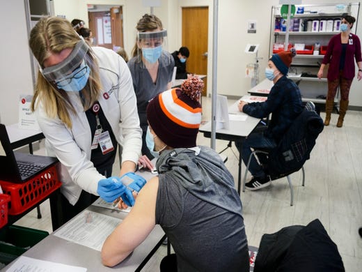 Healthcare workers get their vaccine doses in Ohio.