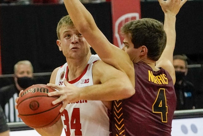 Wisconsin's Brad Davison tries to get past Loyola's Braden Norris during the first half of an NCAA college basketball game Tuesday, Dec. 15, 2020, in Madison, Wis.