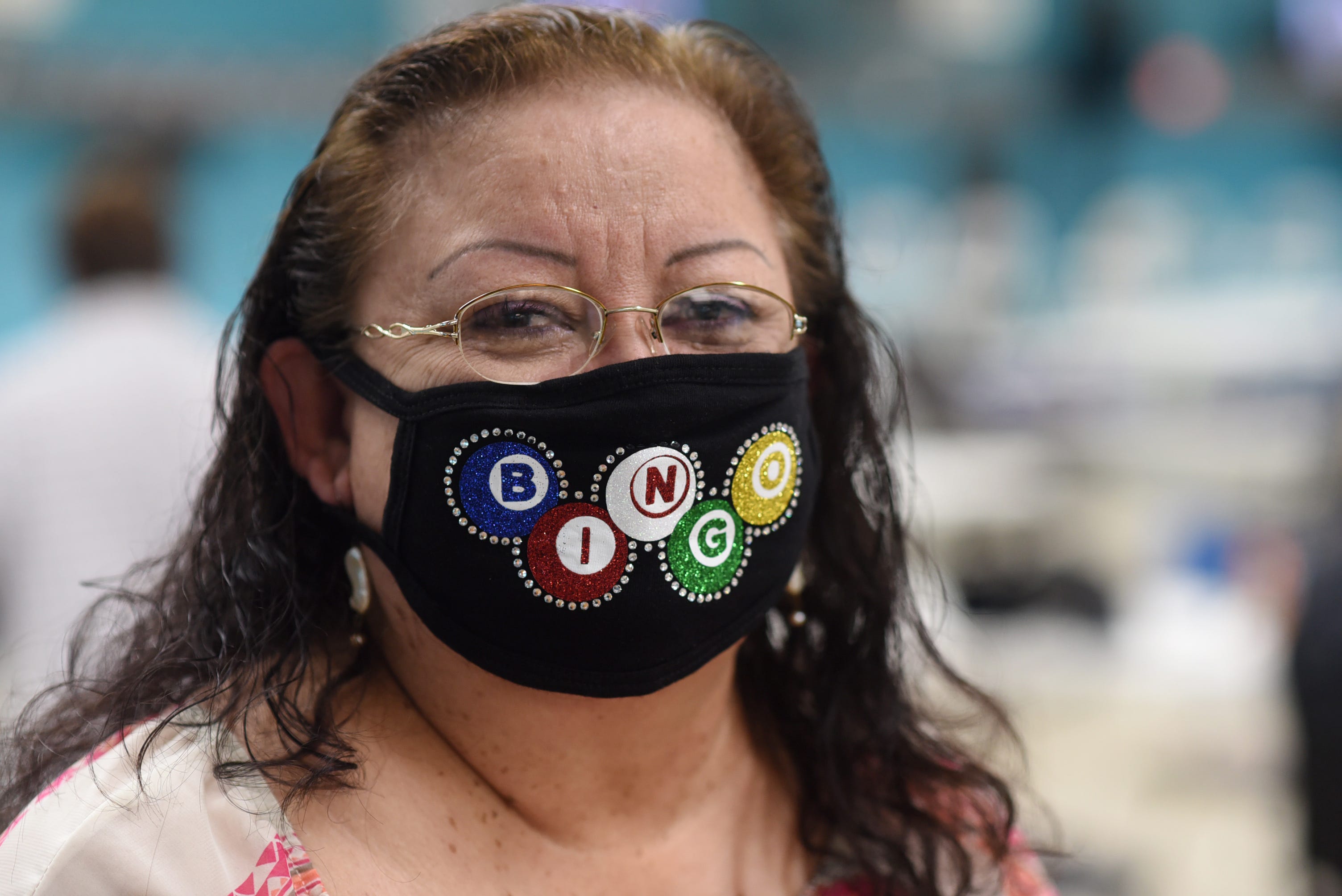 A woman wears a bingo mask at C.C. Bingo Hall on Nov. 22. The halls make everyone wear a mask while playing and have distanced tables to promote social distancing.