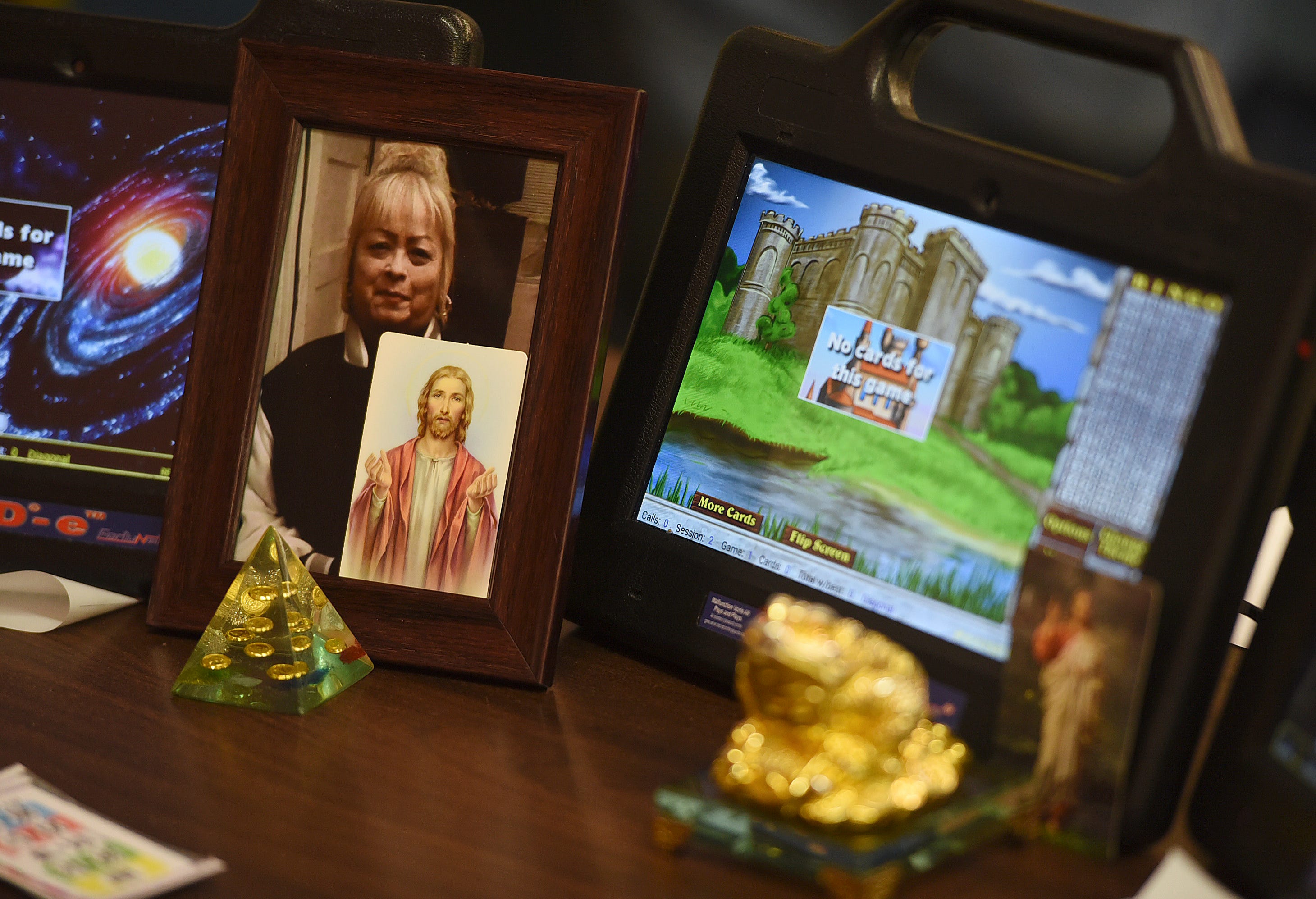 "She's my good luck charm," Jeffe Cuellar says about the framed photo of his late girlfriend at El Mercado bingo hall on Dec. 2. Cuellar uses photos of Jesus Christ and statues for good luck.