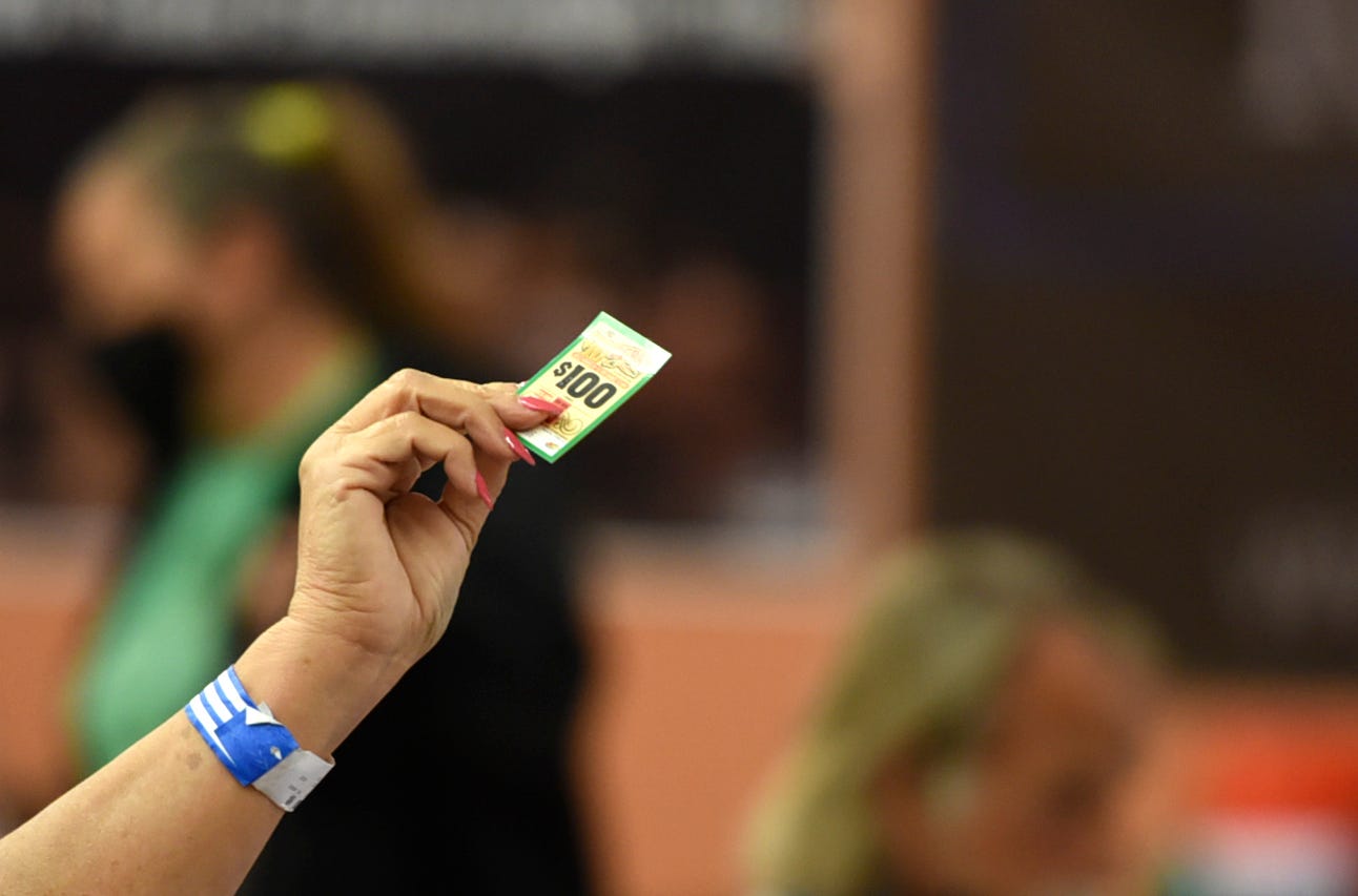 A woman holds her winning pull-tab at El Mercado bingo hall on Dec. 2. Pull-tabs are sold throughout the bingo sessions.