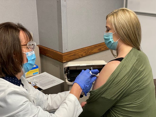 Kayla Kennedy, a critical care nurse at St. Vincent Hospital in Green Bay, receives the COVID-19 vaccination on Wednesday. HSHS Wisconsin and its physician partner, Prevea Health, began administering the first round of COVID-19 vaccines allotted to them for frontline health care workers.