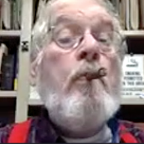 Attorney Thomas McAdam puffs a cigar during a remo