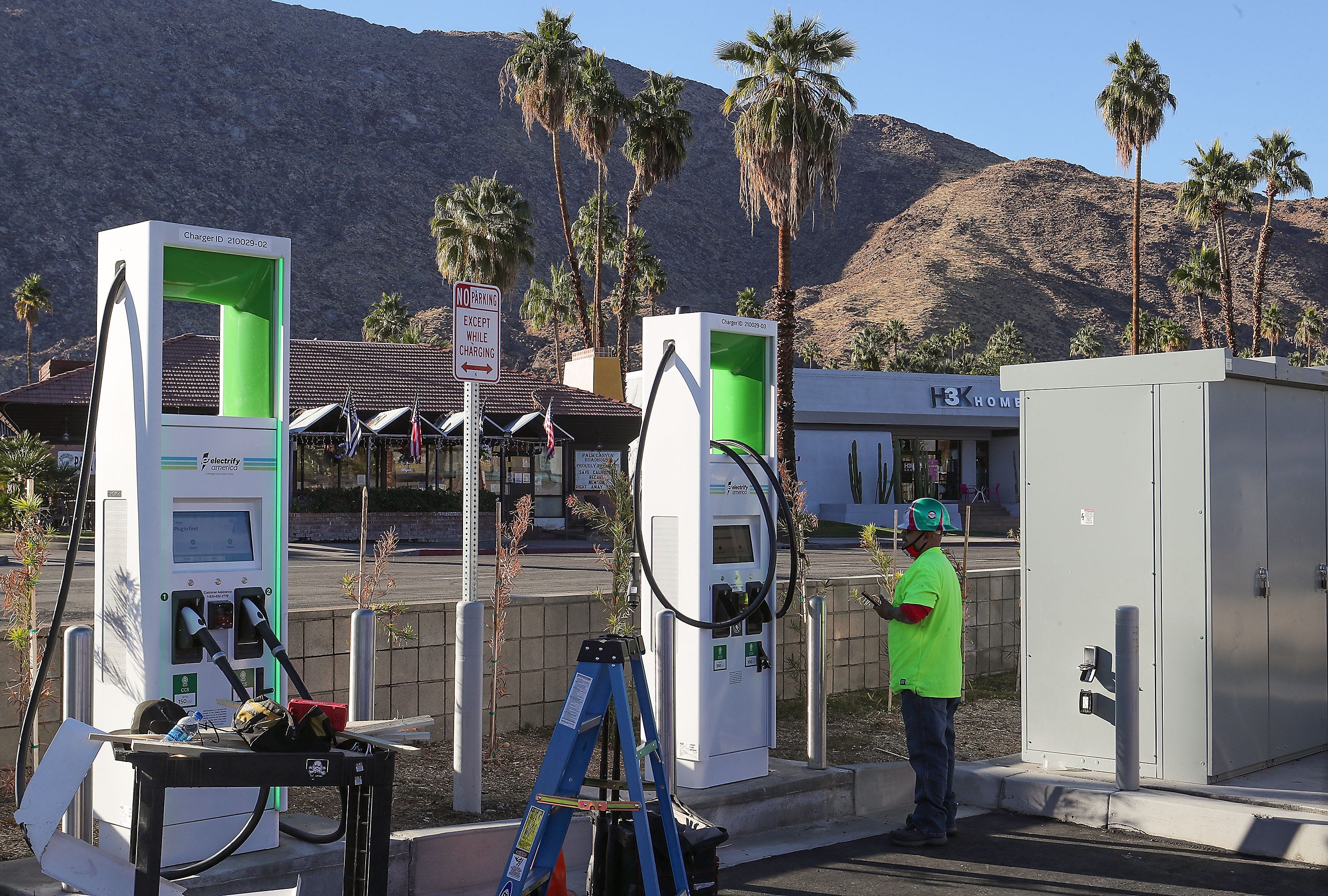 Francisco Diaz installs a new Electrify America charging station in a parking lot in downtown Palm Springs, Ca., December 15, 2020.  The charging stations work similiar to gas pumps and accept debit and credit cards.