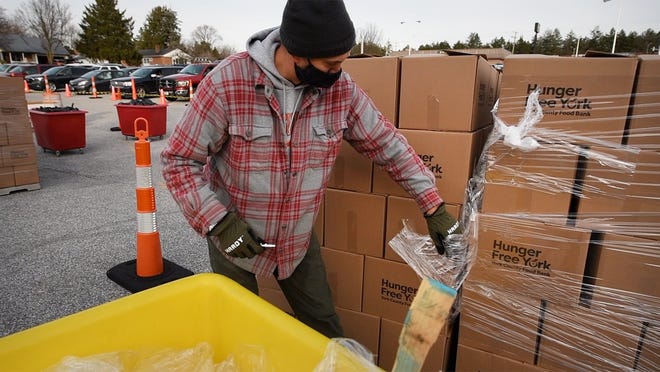 Ryan White, who retired early from a finance job in New York City, has been volunteering at the The York County Food Bank Emergency Food Hub in Springettsbury Township since the pandemic hit last March.