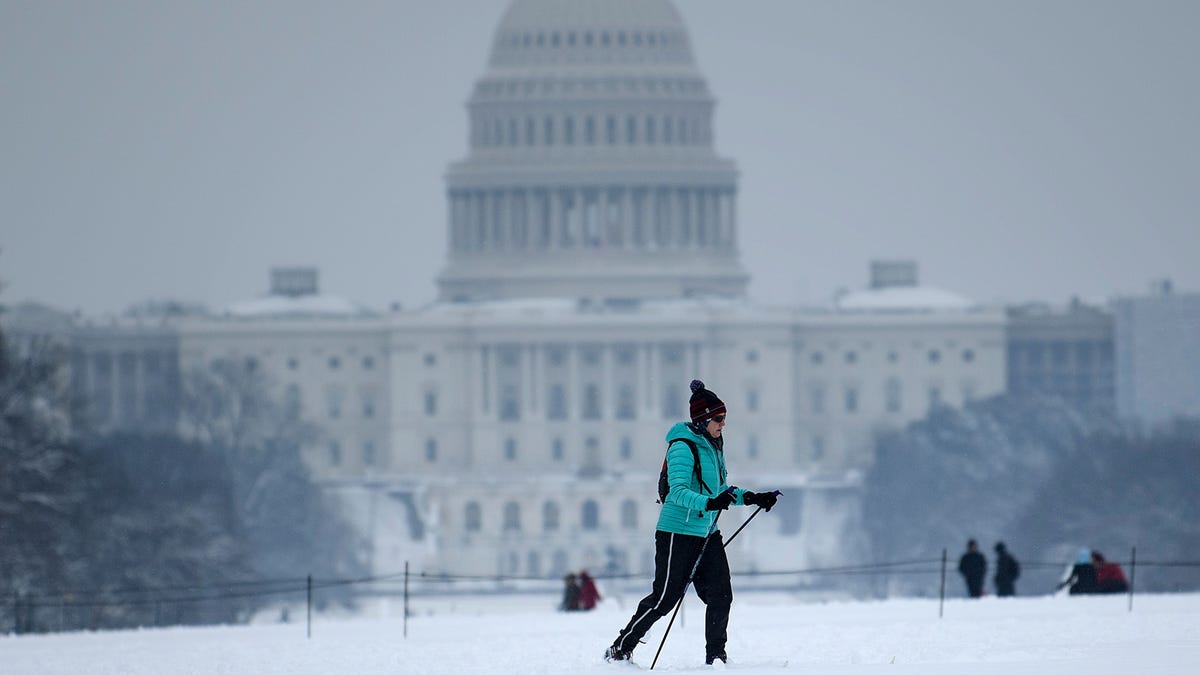 A cross country skier passes the US Capitol on the National Mall on the 23rd day of a government shutdown during a winter storm January 13, 2019 in Washington, D.C.