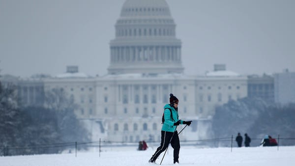 A cross country skier passes the US Capitol on the