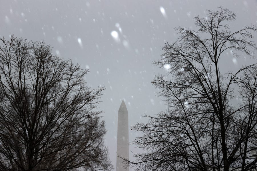Snow falls over the Washington Monument on Dec. 16 as a wintry mix of precipitation swept along the Mid-Atlantic and Northeast.