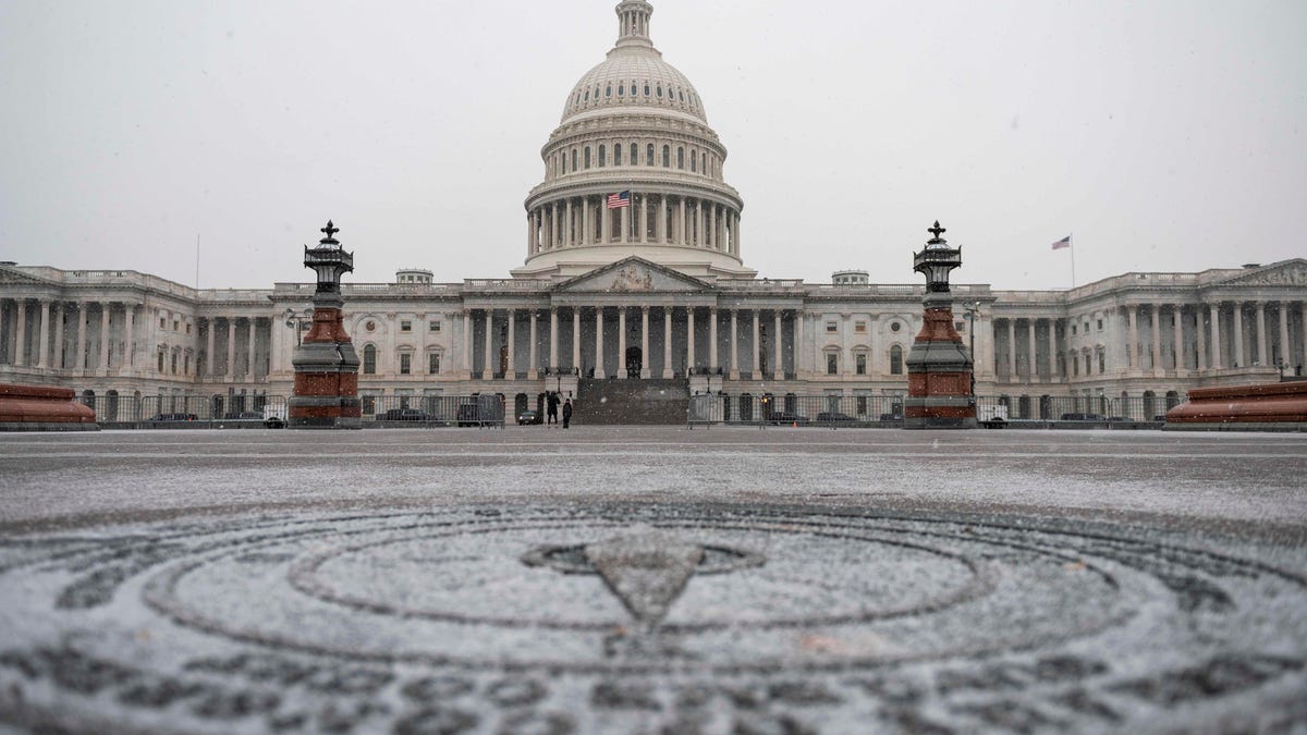 The US Capitol is seen as a snow storm develops in Washington, DC on December 16, 2020.