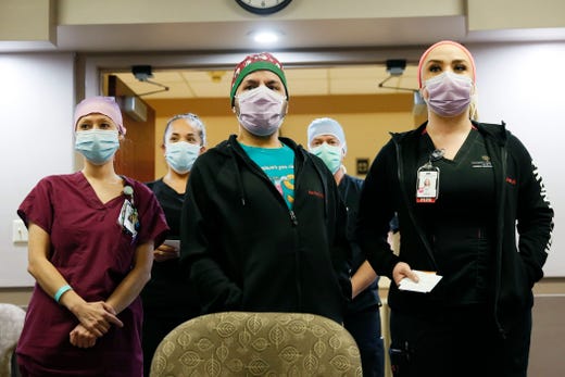 Robin Stemerman, from left front, Raul Garcia, Sarah Ellis, Crystal Molina, back left, and Ricardo Martinez, back right, are the first people in El Paso to receive the COVID-19 vaccine at University Medical Center of El Paso Tuesday Dec. 15, in El Paso. Over the next few days, it should receive about 2,900 doses of the vaccine, officials said.
