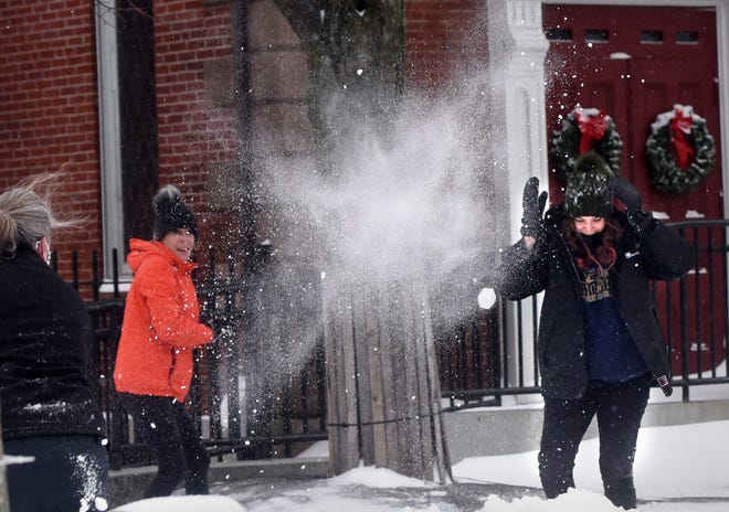 About 30 people showed up in Market Square to have an impromptu snowball fight in Portsmouth as a snow storm rips through the Seacoast Thursday. 