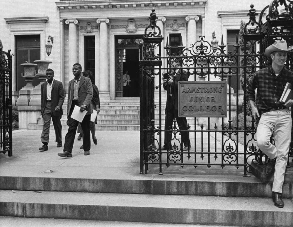 Black students arrive for classes the former Armstrong Junior College building. The entrance was supervised by police and spectators were kept at distance. Sept. 1963.