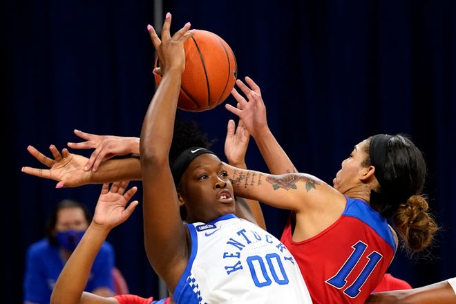Kentucky center Olivia Owens, left, battles for a rebound against DePaul guard Sonya Morris in Chicago on Wednesday.