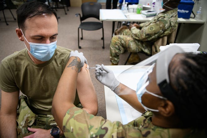 Maj. Nathan Wagner receives a COVID-19 vaccination from Sgt.  Paula Smith at Fort Bragg in December 2020. The Army announced this month that it will separate Soldiers who refused the vaccine.