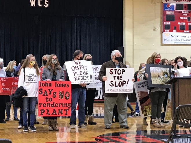 People bearing signs opposing the proposed rendering plant were invited to stand behind Sen. Andrew Jones Thursday as he announced a bill designed to keep such plants out of Etowah County.