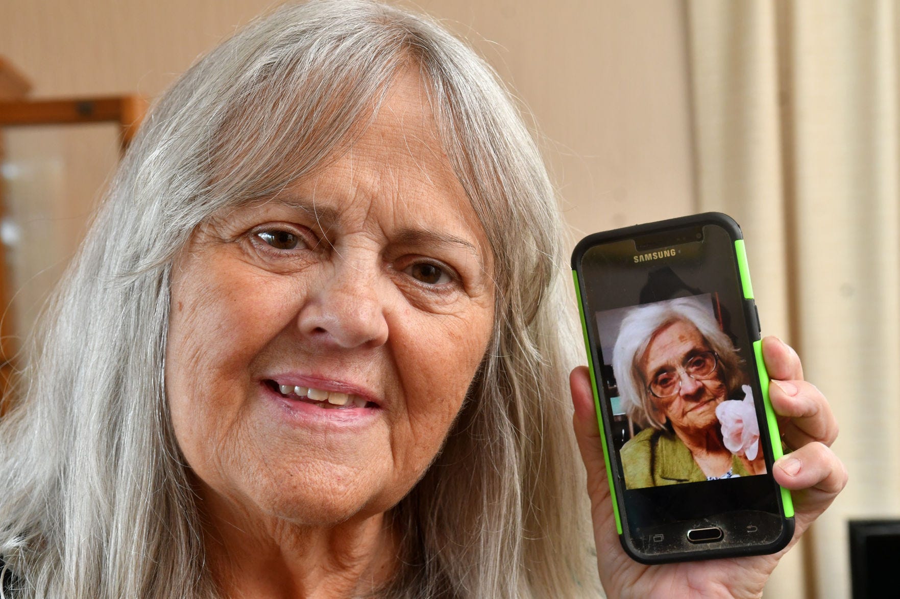 Sally Munson, of Cordova, shows a cellphone photo of her mother,  Eleanor Moody Pettit, 99, who died recently of COVID-19. Eleanor's glass was "always half full," Munson said.