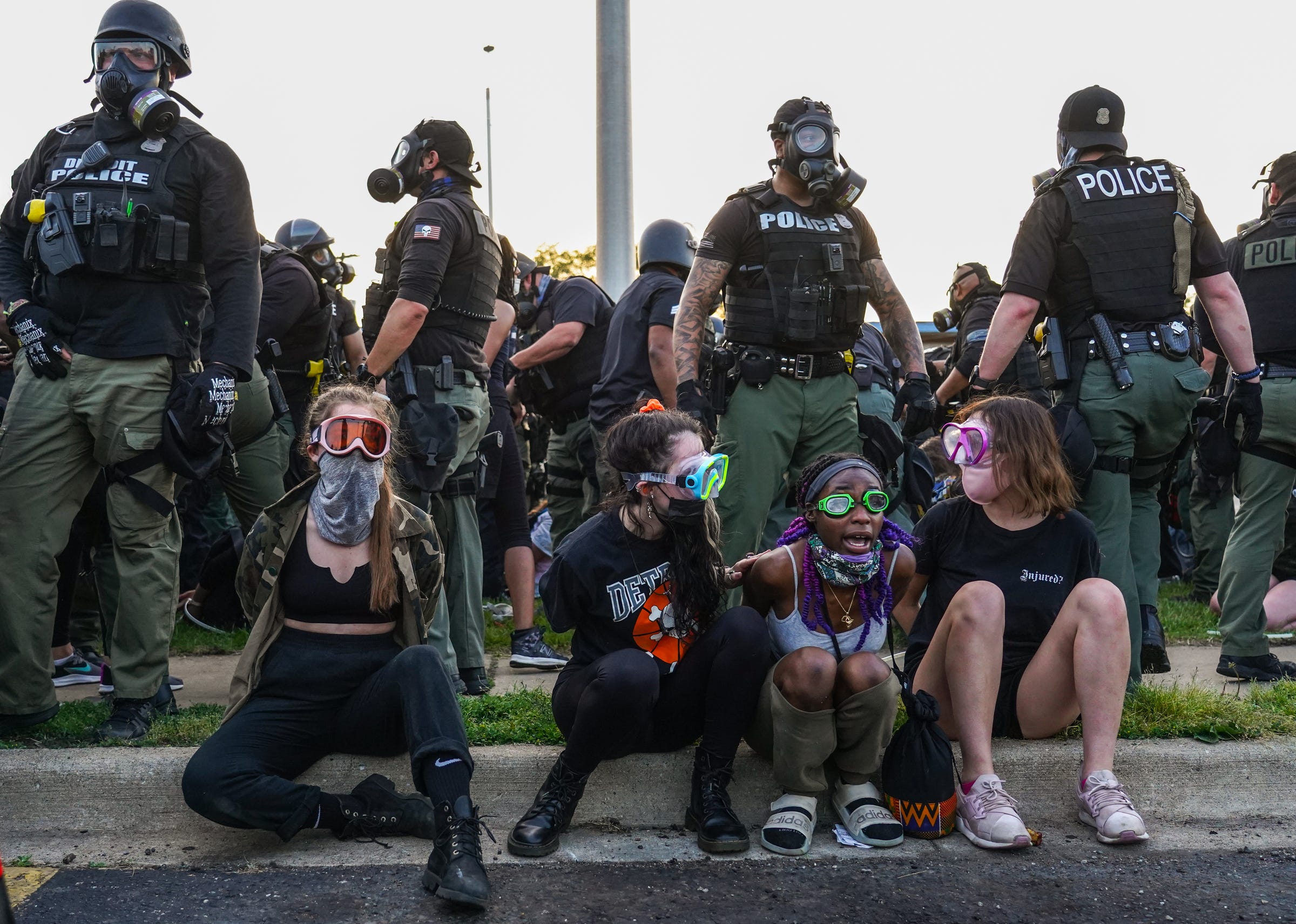 Detroit police officers arrest protestors on Gratiot Avenue after the protestors had resisted an 8 p.m. curfew in Detroit on Tuesday, June 2, 2020.