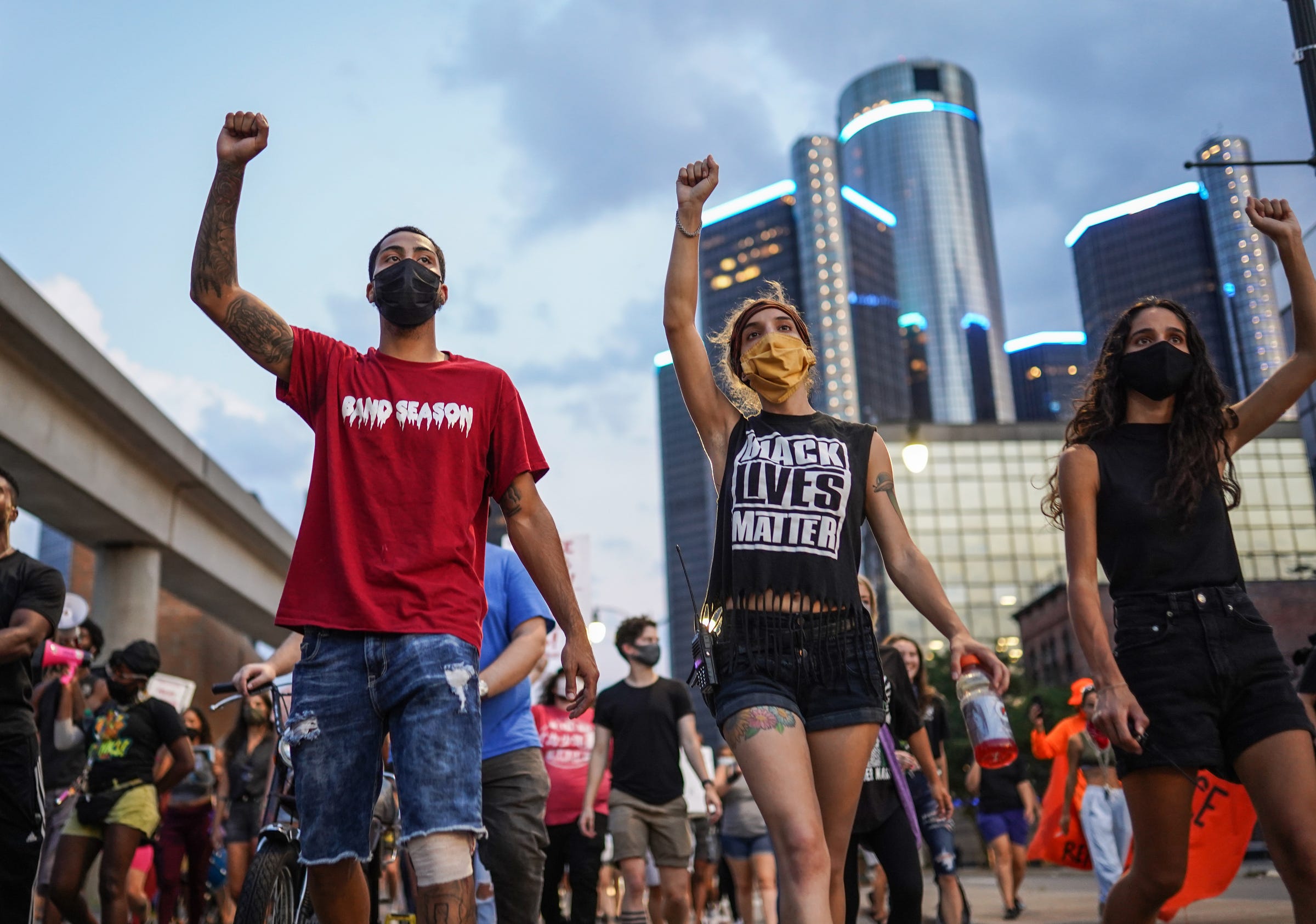 (Left to right) Detroit Will Breathe members Dwane Taylor of Detroit, Alexis Olechowski of Detroit and Sahar Faraj of Detroit march with others against police brutality along Brush Street in downtown Detroit on Thursday, August 27, 2020.