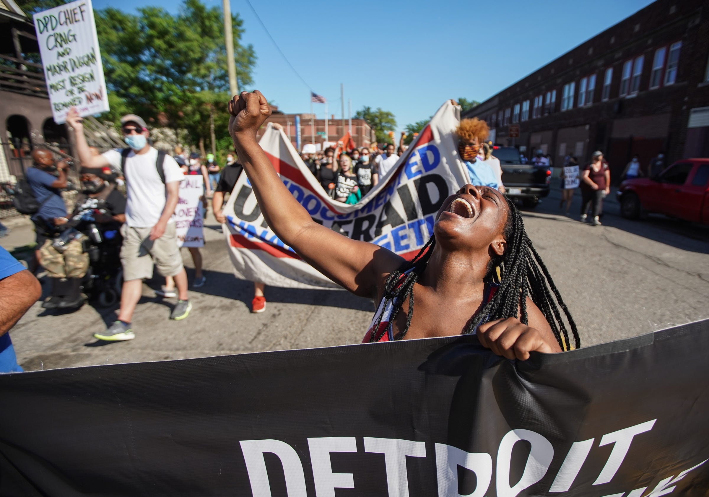 Shaqualla Johnson of Detroit shouts a chant while marching with other protesters in southwest Detroit neighborhood on Monday, June 29, 2020.