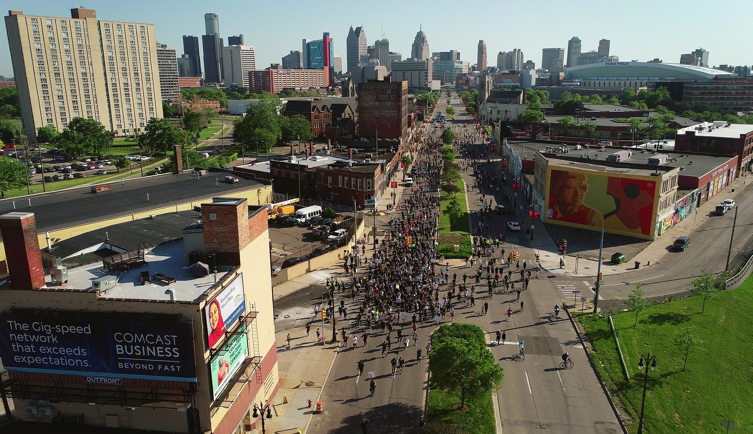 A large group marches north on Gratiot Avenue past Eastern Market and a mural of Rosa Parks during the fifth day of protesting police brutality and the death of George Floyd in Detroit on June 2, 2020.