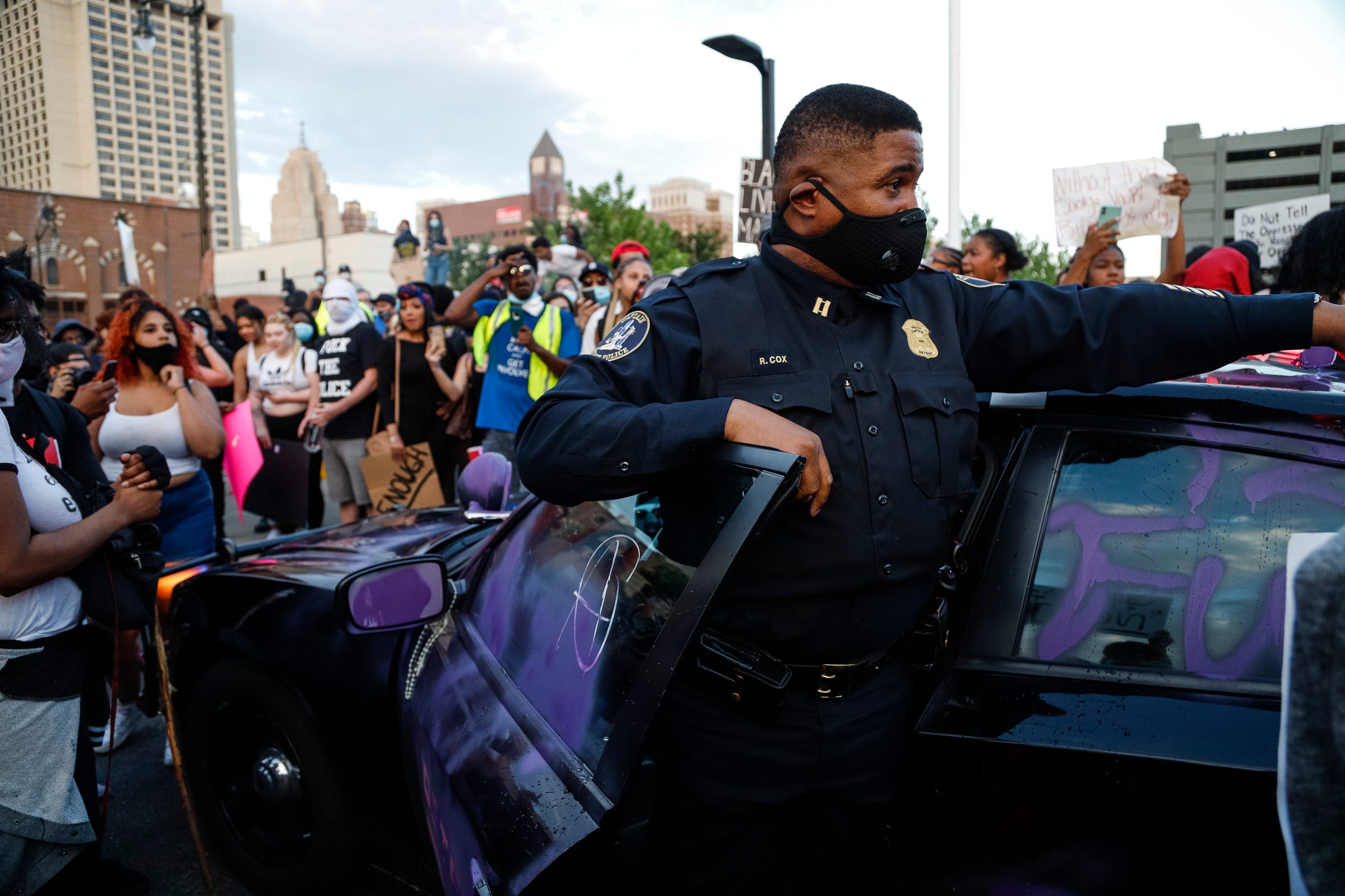 Protesters vandalized a Detroit police vehicle in front of the Detroit police headquarters as hundreds gathered and marched through Corktown and downtown to protest police brutality and the death of George Floyd, Friday, May 29, 2020.