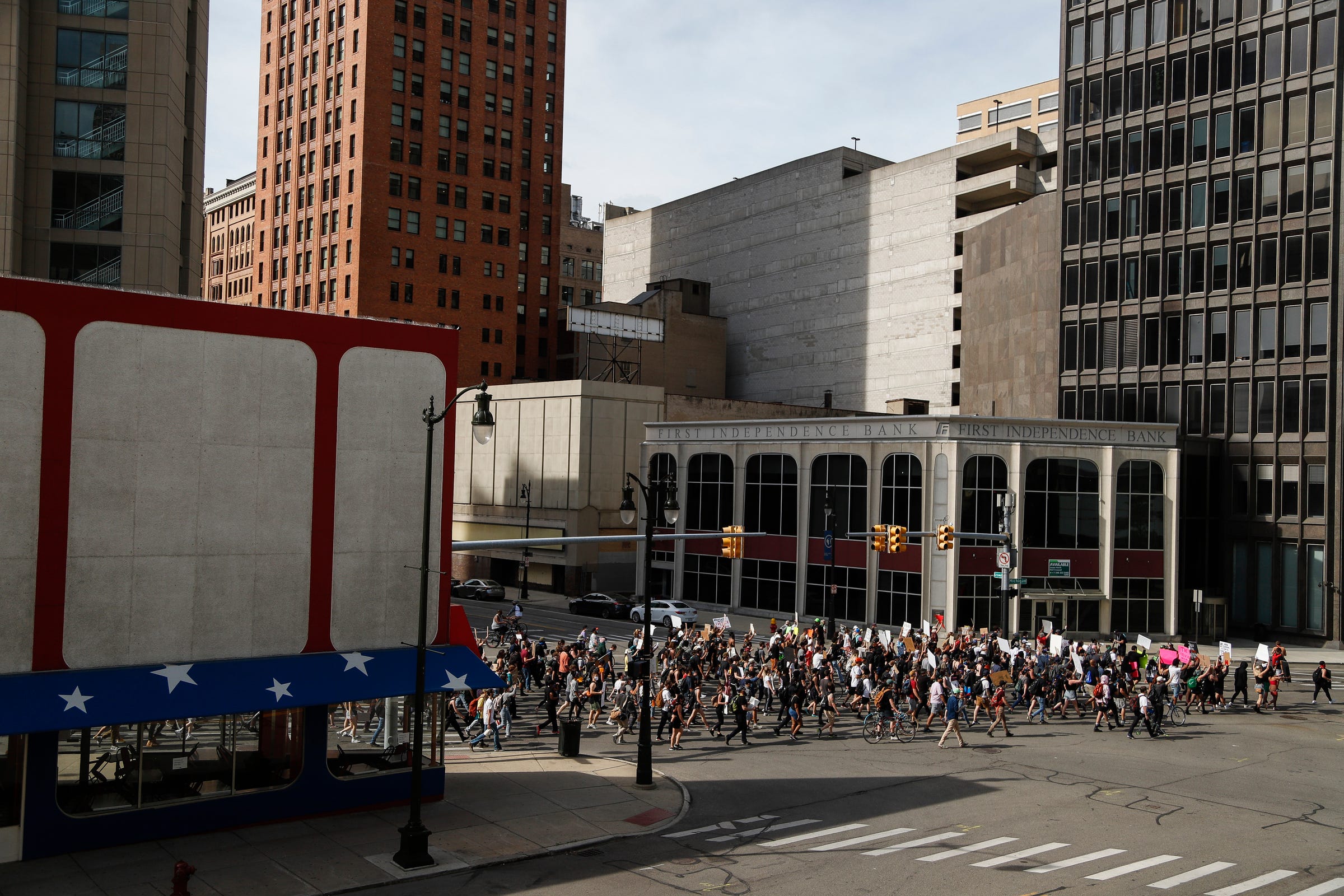 Protesters march by American Coney Island in downtown Detroit, Wednesday, June 3, 2020.