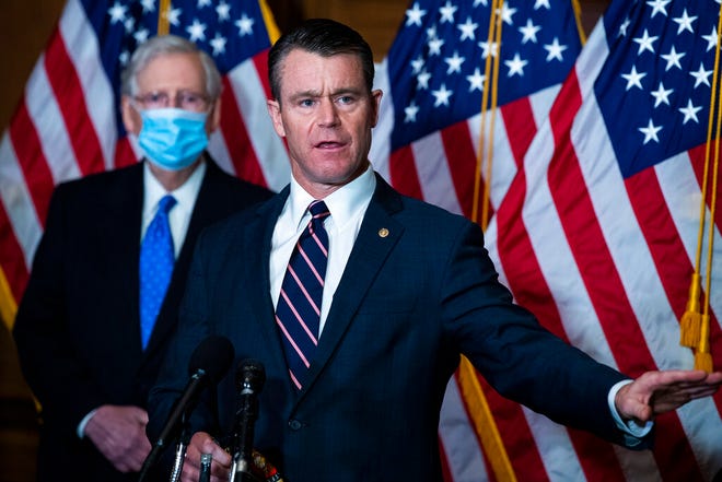 Senate Majority Leader Mitch McMcConnell of Ky., listens as Sen. Todd Young, R-Ind., speaks to reporters on Capitol Hill in Washington, Tuesday, Dec. 1, 2020. (Tom Williams/Pool via AP)