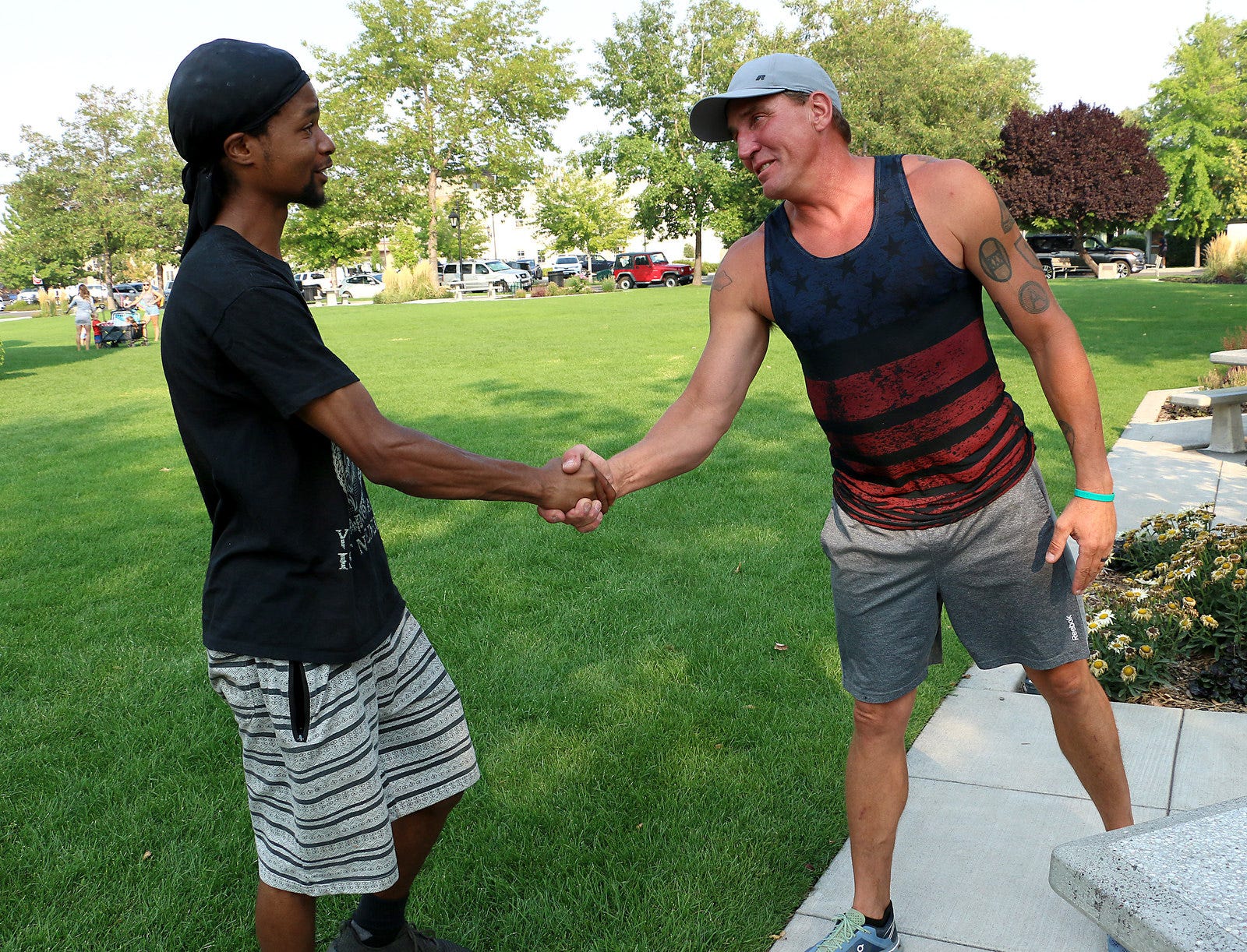 Jerome Silas, left, and Brian Johnson shake hands while meeting in Minden Park in Minden on Aug. 25, 2020. A striking image was taken of Silas and Johnson during a Black Lives Matter protest that attracted about 50 supporters and more than 1,500 counter-protesters in Minden Aug. 8. The two fathers from Northern Nevada were from opposite sides of a conflict with the same goal: to protect their community. The RGJ invited them to meet and talk about the experience and the impact that moment, and that day, had on them.