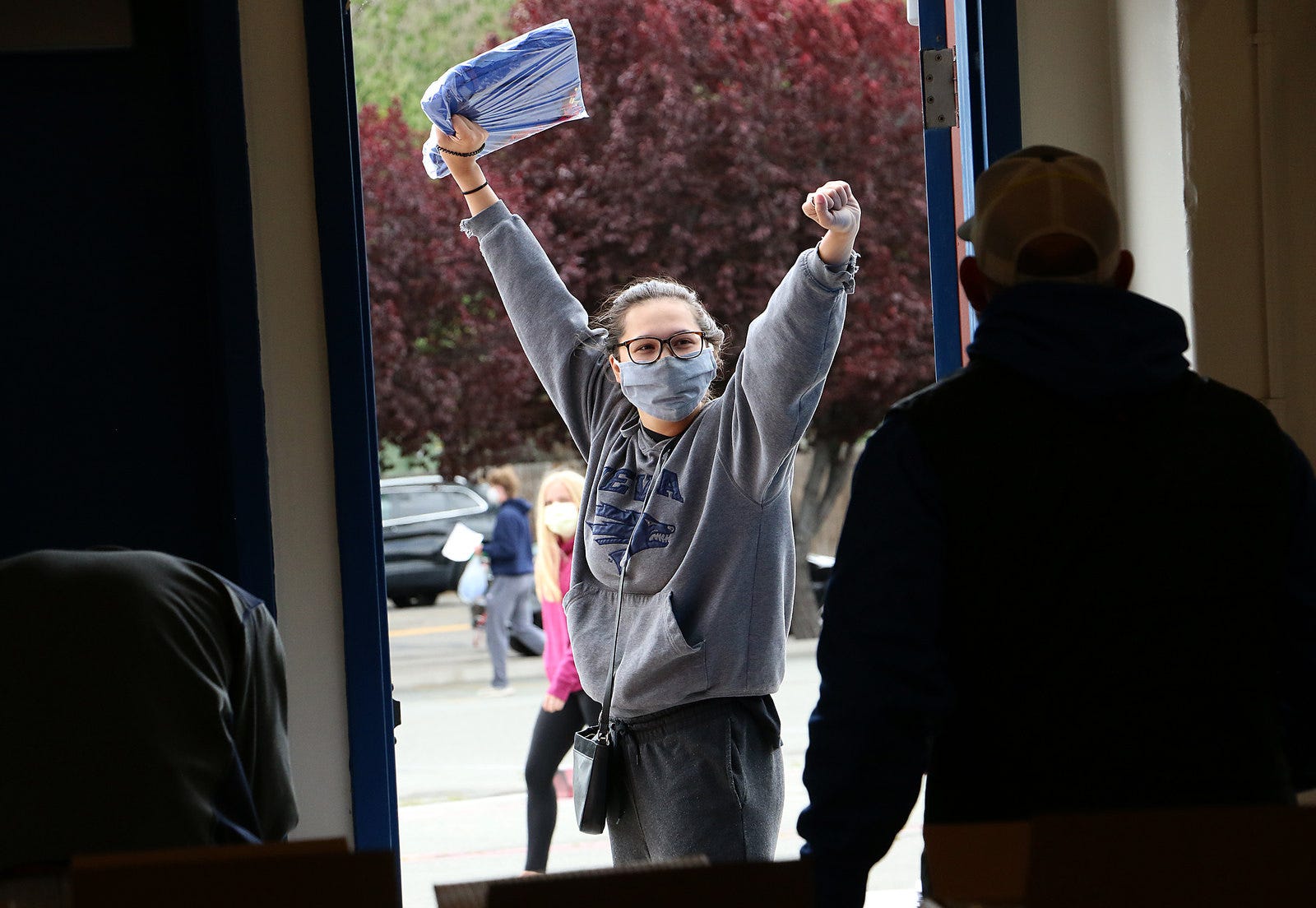 Senior Emma Gonzalez reacts after receiving her graduation cap and gown while collecting her belongings from Reno High School on May 19, 2020. Gonzalez will be attending the University of Nevada, Reno next school year.