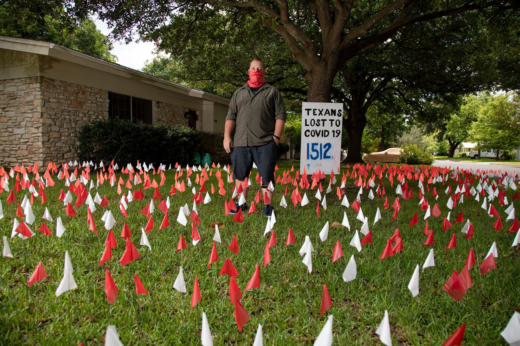 Austin artist Shane Reilly, 42, puts plastic flags in his yard to reflect the number of coronavirus deaths in Texas.  "I just felt that I had to say something so this was my way of reminding the public that there are real people dying," Reilly said. He continues to add flags every few days to keep up with the current number of state deaths. The current number of Texas fatalities as of May 26, 2020, is 1,527 according to the Texas Department of State Health Services.