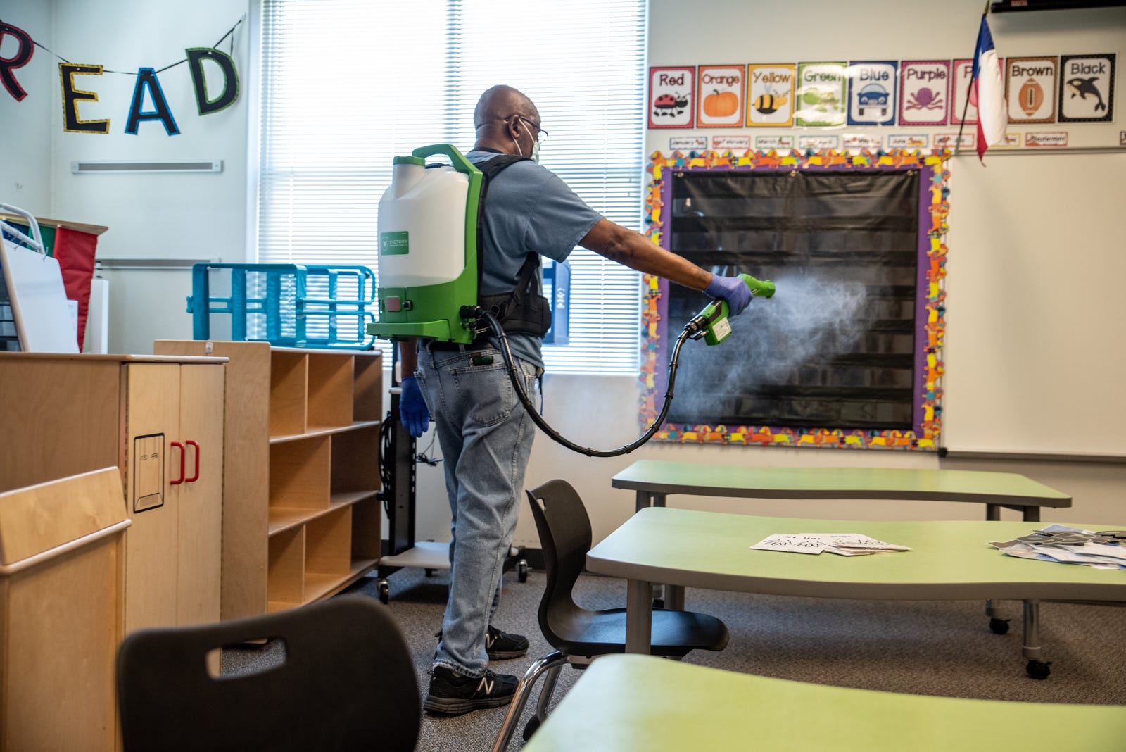 A custodian cleans a classroom at Akin Elementary in Leander, Texas on Thursday, July 16, 2020. The school has been preparing for possible return of students by cleaning and disinfecting classrooms to help prevent the spread of coronavirus. Sergio Flores for AMERICAN STATESMAN
