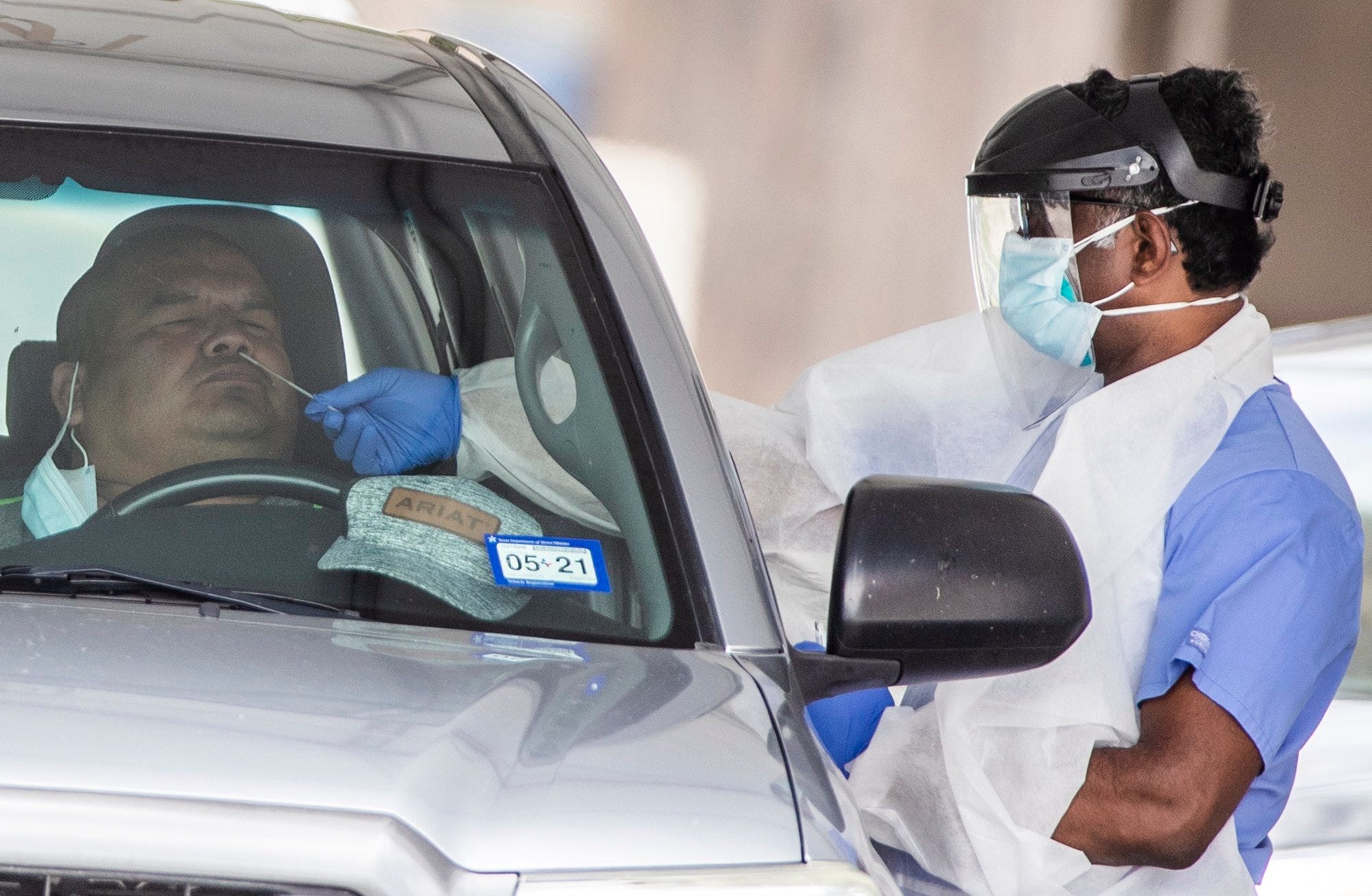A man is tested for COVID-19 at a drive-through testing site at Community Care at the Hancock Center on Wednesday, June 29, 2020, during the coronavirus pandemic.
