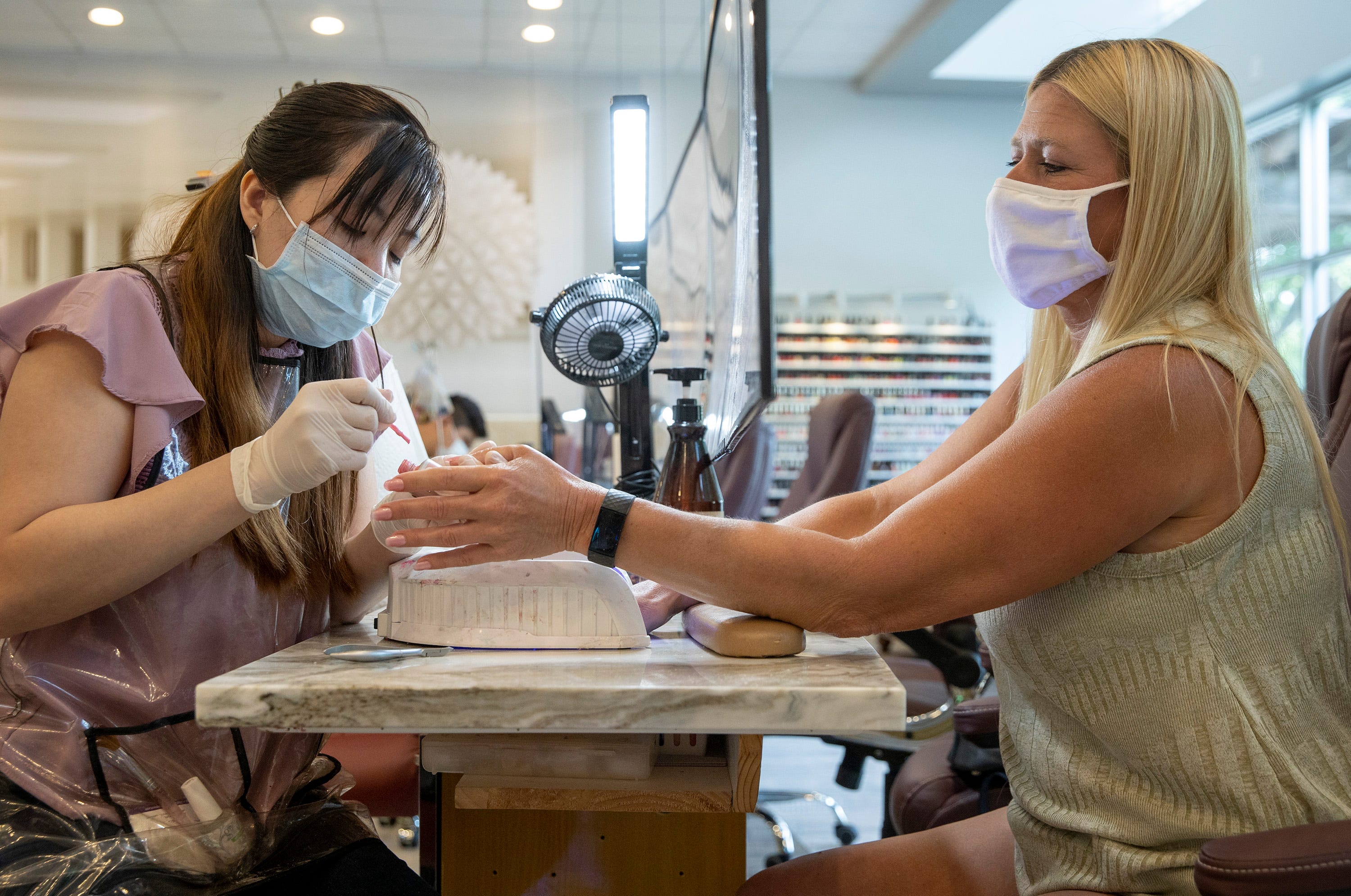 Shelley Pelton, right, gets a manicure from Lan Nguyen at Oasis Day Spa and Nails on West Slaughter Lane on Friday May 8, 2020.  Friday was the first day salons and barbershops were allowed to open after the coronavirus shut down.