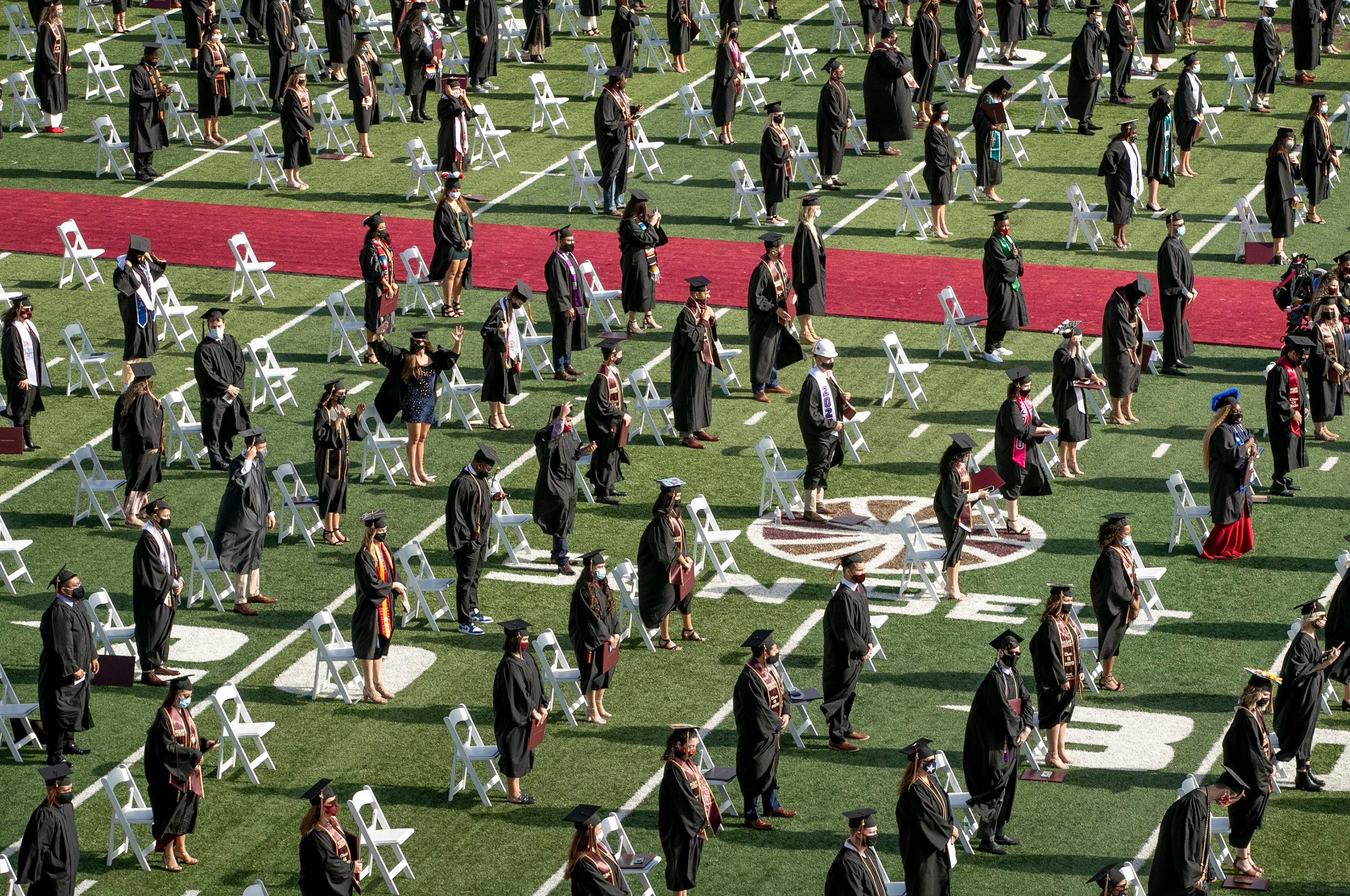 Texas State University graduates stand to be recognized at a commencement ceremony at Bobcat Stadium in San Marcos on Thursday December 10, 2020.   Spring and summer graduates participated in two socially distanced, outdoor commencement ceremonies on Thursday, and the fall candidates will graduate on Friday.