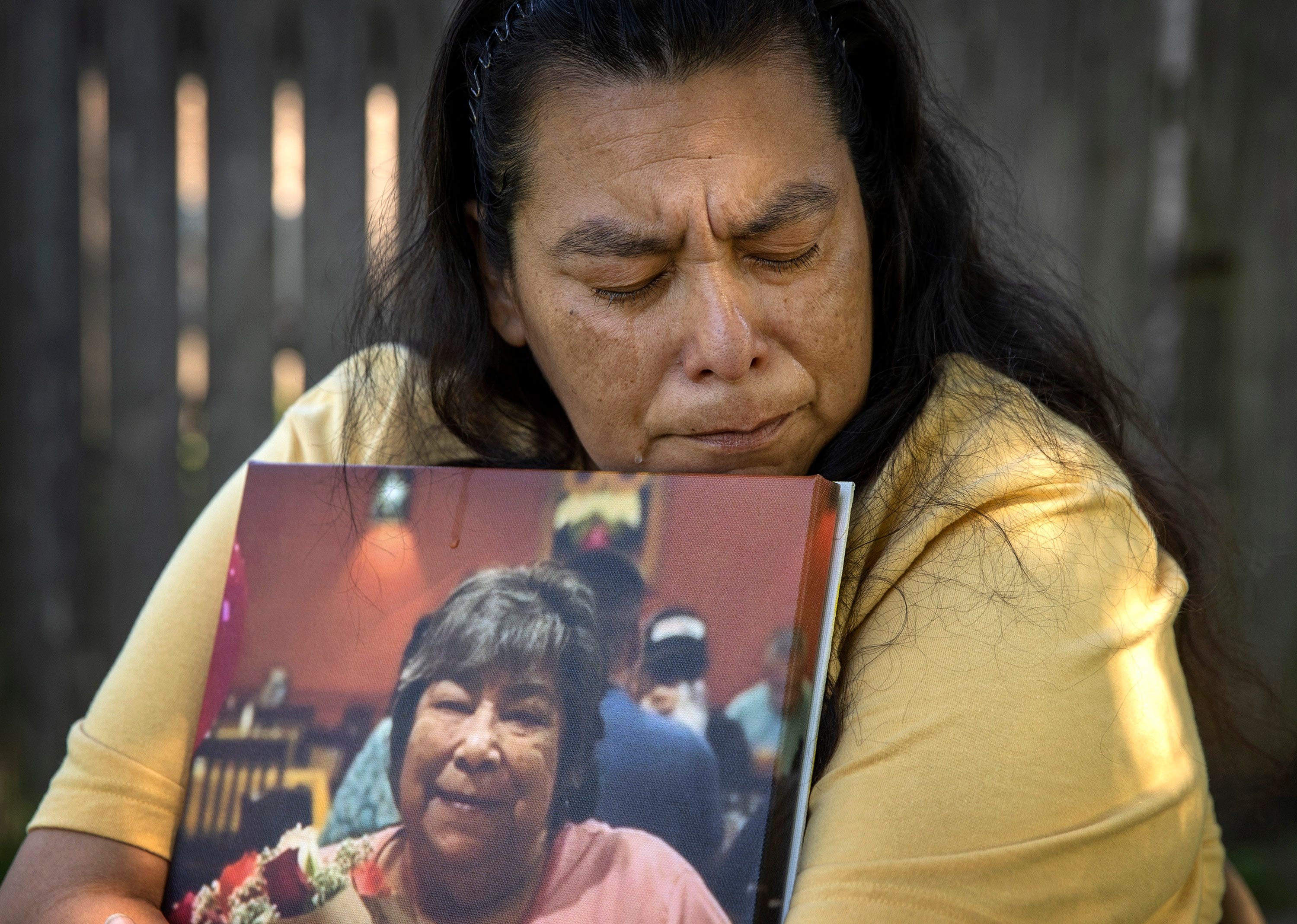Maria Ortega holds a photo of her mother Rachel Luna at her home in north Austin on Wednesday May 6, 2020.  Luna, a resident at West Oaks Nursing and Rehabilitation Center, died of COVID-19.