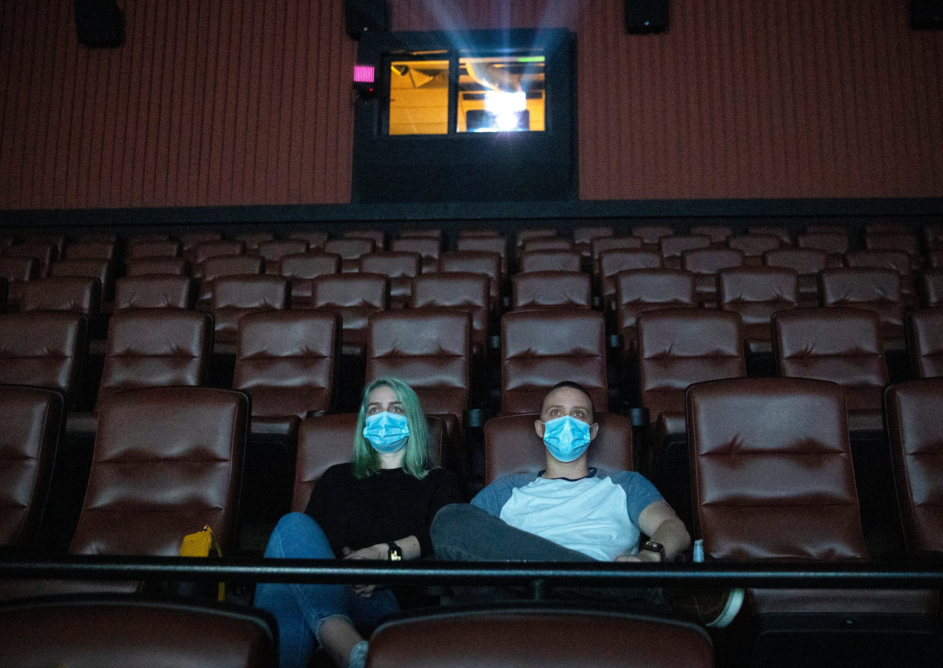 Kayleigh Tansey and Justin Smith, of Kyle, watch the movie "The Invisible Man" at EVO Entertainment on Monday May 4, 2020.  The movie theater in Kyle reopened Monday after Gov. Greg Abbott last week lifted the shelter in place order and allowed retail stores, restaurants and some other businesses to open to the public at no more than 25% capacity.