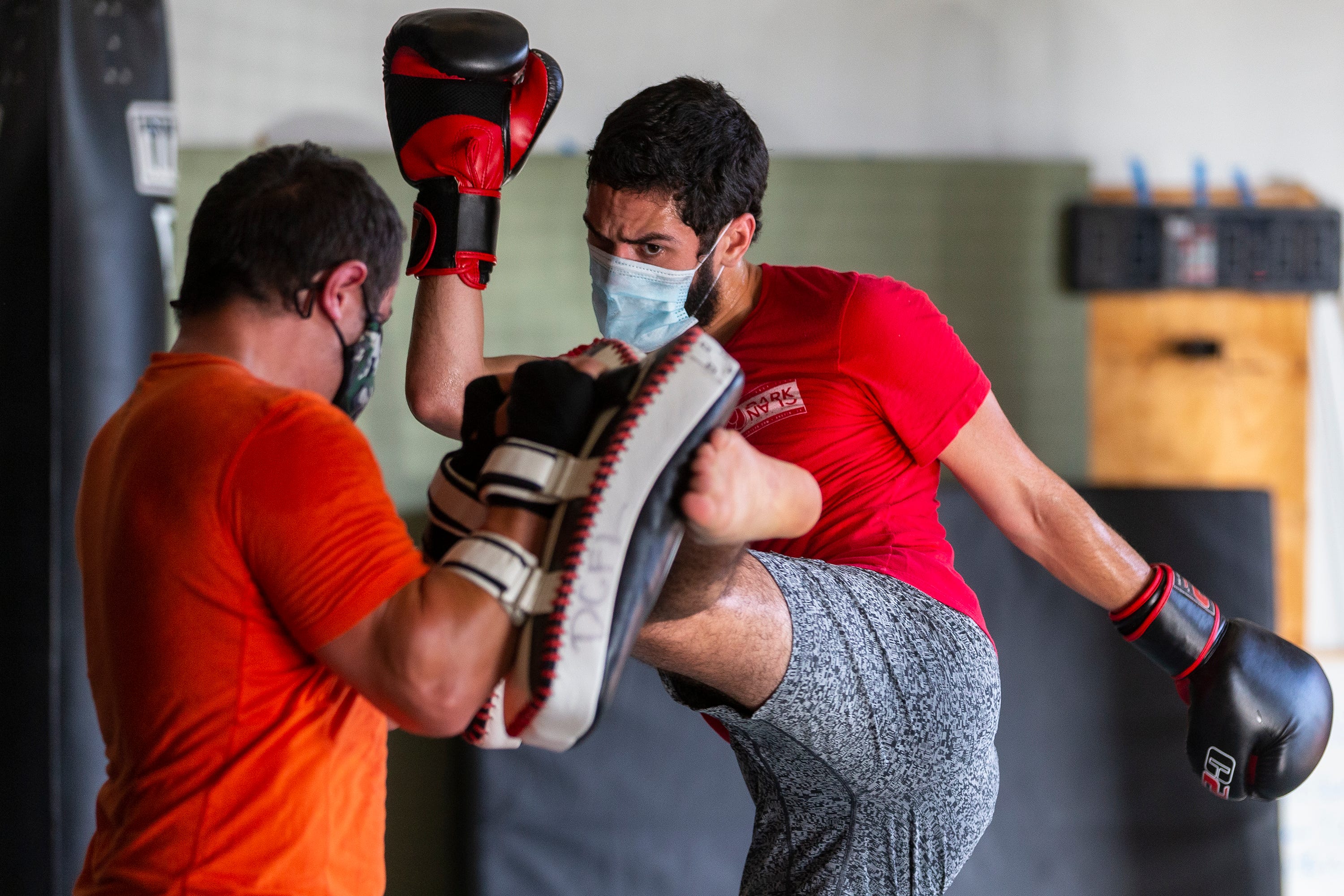 Pablo Rivera, right, works out with Mike Leboeuf during a kickboxing class at Dark Clan Fight Lab in east Austin, Wednesday, July 8, 2020. The gym was able to open Wednesday with new practices to keep their members safe due to Coronavirus.