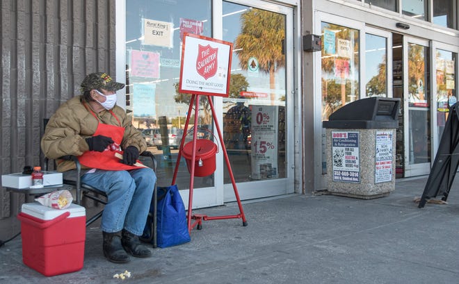 Dave Campfield rings a bell for the Salvation Army at the Rural King in Leesburg on Thursday, Dec. 17, 2020. Campfield says the church has had a harder time finding volunteers this year because of the COVID-19 pandemic. [PAUL RYAN / CORRESPONDENT]