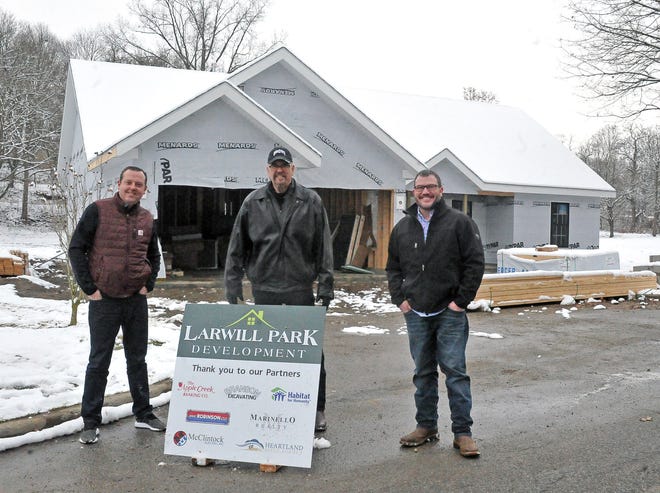 Justin Starlin, Tom White and Chad Boreman stand in front of the unfinished house on West Larwill Street in Wooster. The businessmen, along with several silent partners and local businesses, are building a home to add more affordable housing in the city.