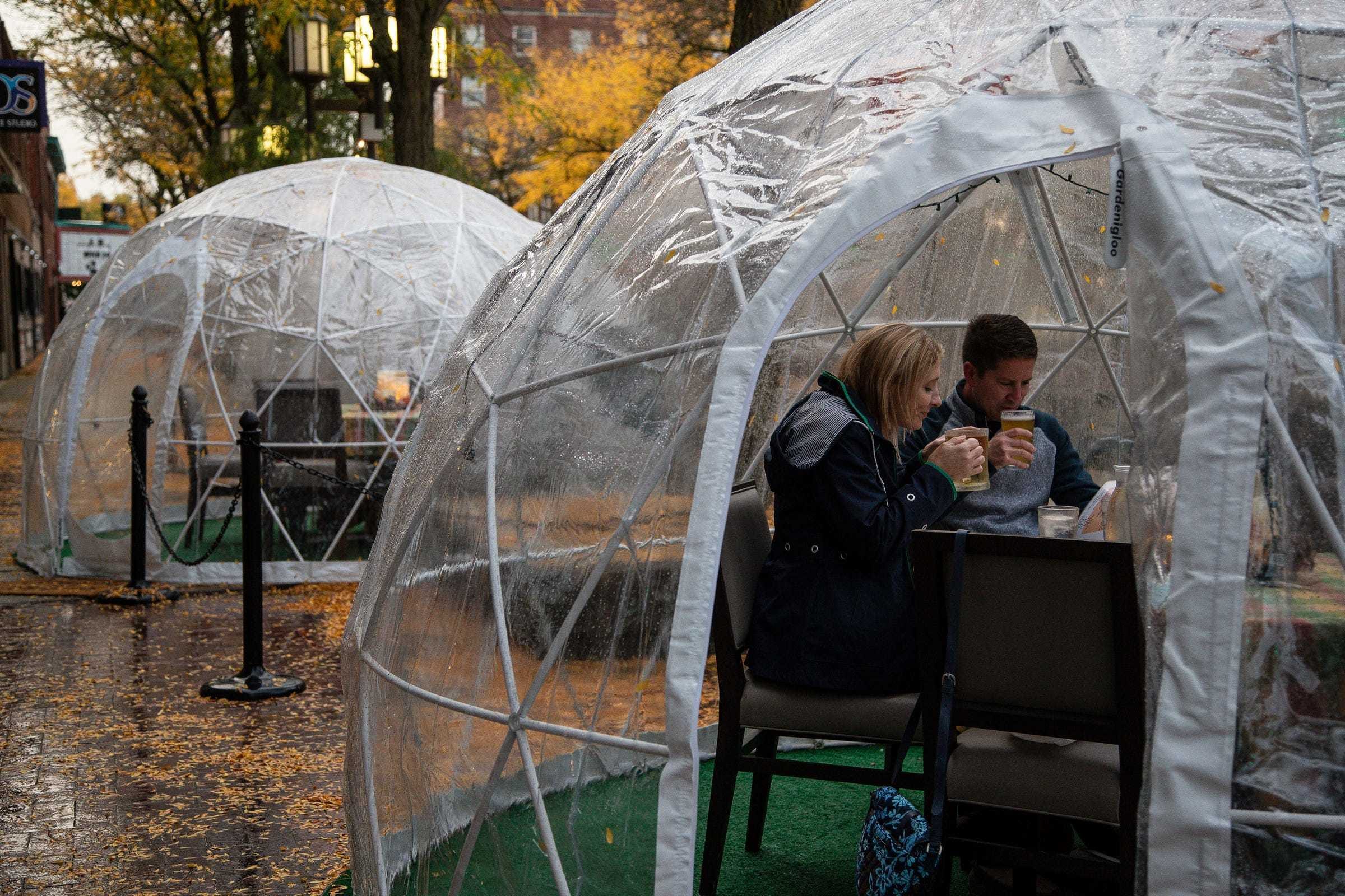 Melanie Deisler and her husband Rick, both of Ypsilanti Township, get ready to order food to celebrate their 20th wedding anniversary inside of an igloo outside of Bobcat Bonnie's in downtown Ypsilanti, Wednesday, Sept. 30, 2020.