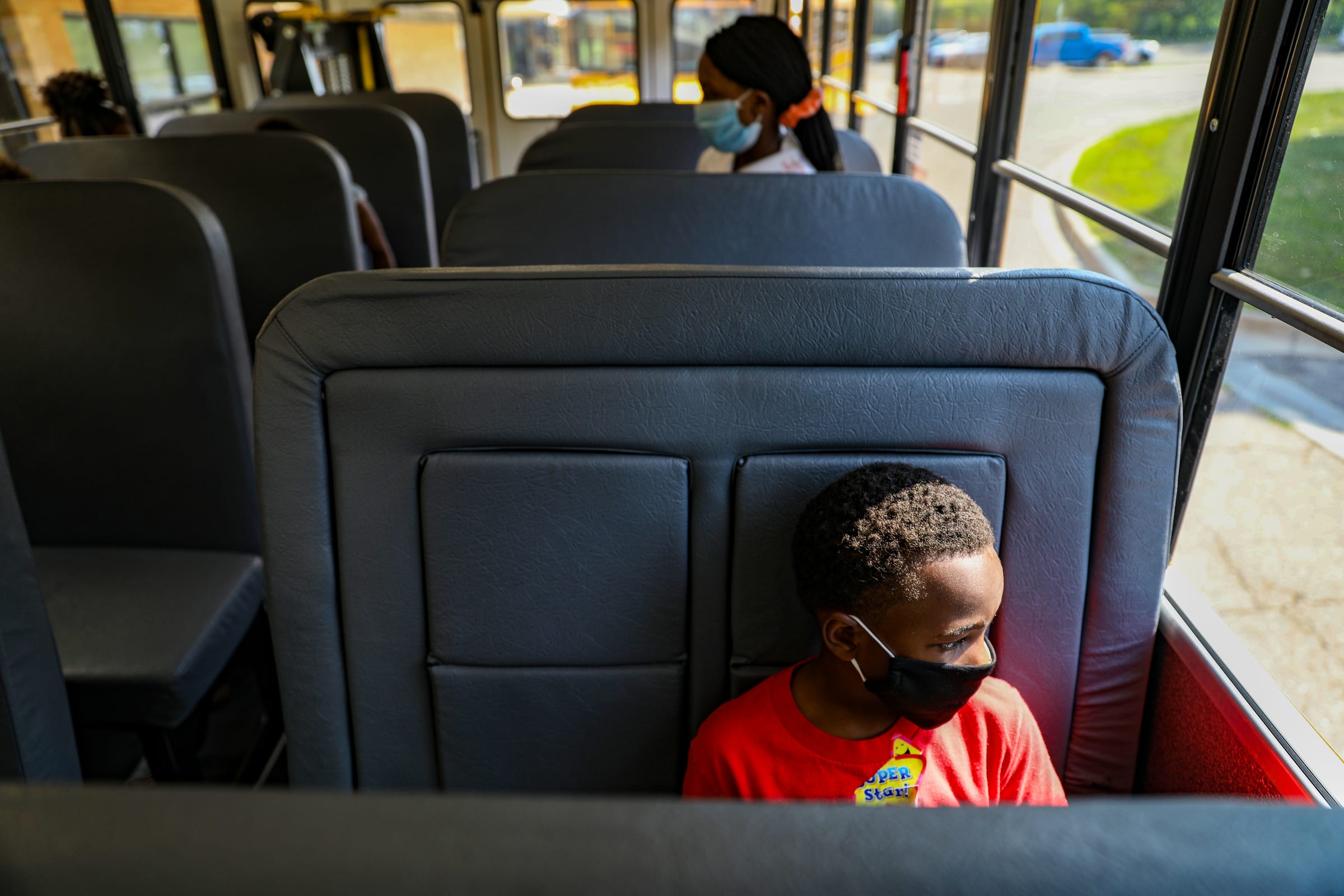 Students board their buses with help from teachers after their first day of school at Sheiko Elementary School in West Bloomfield, Mich. on Thursday, Aug. 27, 2020. West Bloomfield offered face-to-face instruction four days a week to students in kindergarten through eighth grade. The students were split into two groups. One attends in the morning and the other in the afternoon.