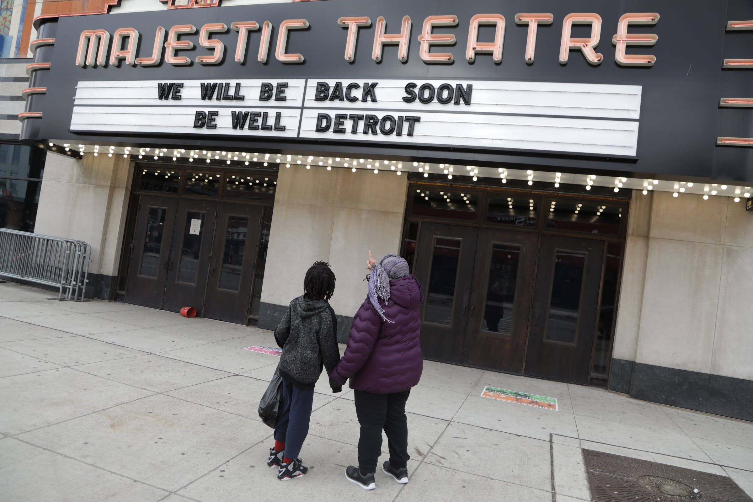 Flossie Norton, 68, of Detroit checks out the Majestic Theatre marquee as she and her grandson Michael Morgan, 10, of Detroit get out for some fresh air. "The streets are naked" said Norton.