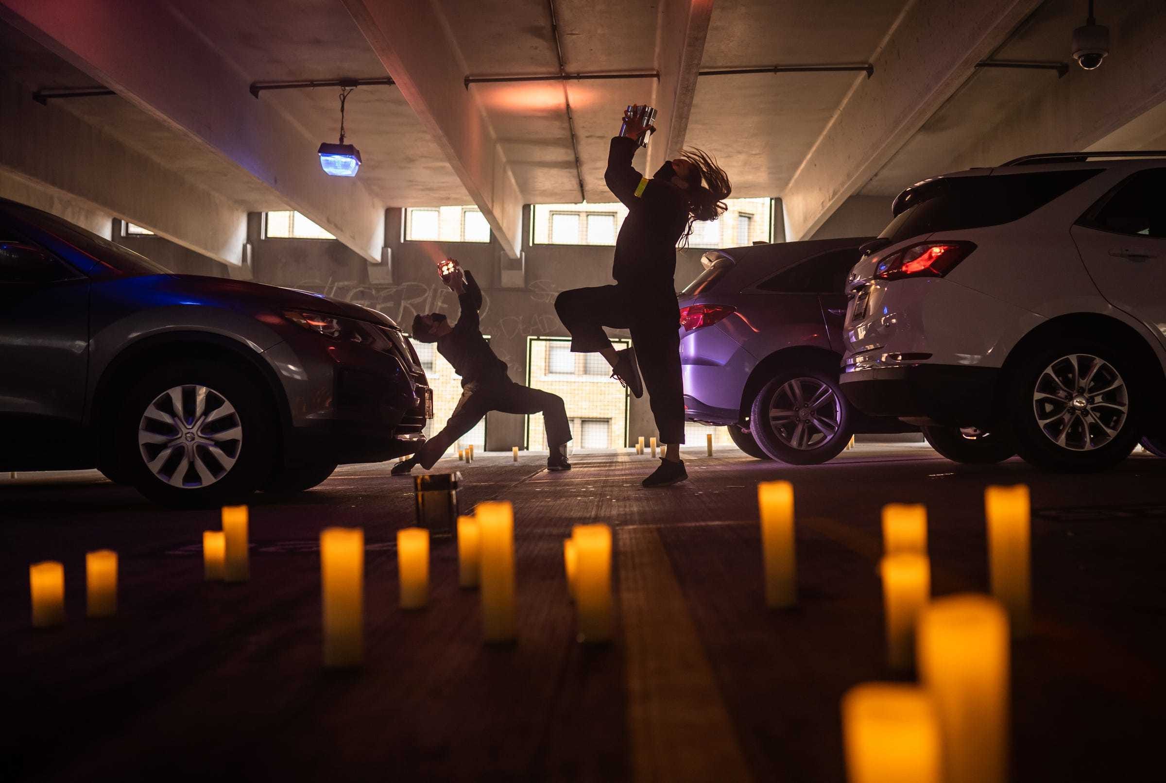 Dida Bell, center, performs a light dance with Wayne State University dance students during a drive-in opera performance of "Twilight: Gods" in the parking structure of the Detroit Opera House in downtown Detroit on Oct. 21. The English-language adaptation of Richard Wagner’s legendary "Götterdämmerung"  was staged downtown in the Detroit Opera House parking garage for opera and live-performance fans who have been barred from theaters for months amid the health restraints and cancellations imposed by the coronavirus pandemic. Each scene took place on a level of the six-story garage, with more than 100 parking ushers guiding eight cars at a time to and from each vignette. Singers and instrumentalists wore microphones, and drive-in guests were instructed to tune their radios to a new station for crystal-clear audio on each floor.